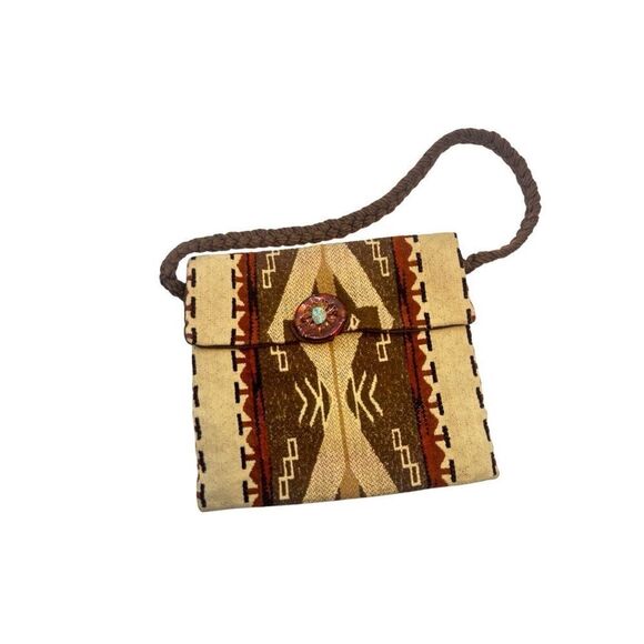 This is a bohemian-style shoulder bag with a braided strap. - Picture 1 of 8